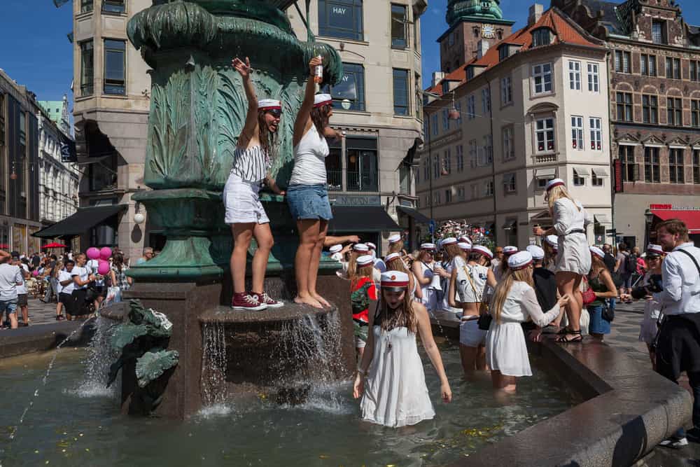 students celebrating as a tradition while following the Danish graduation cap rules
