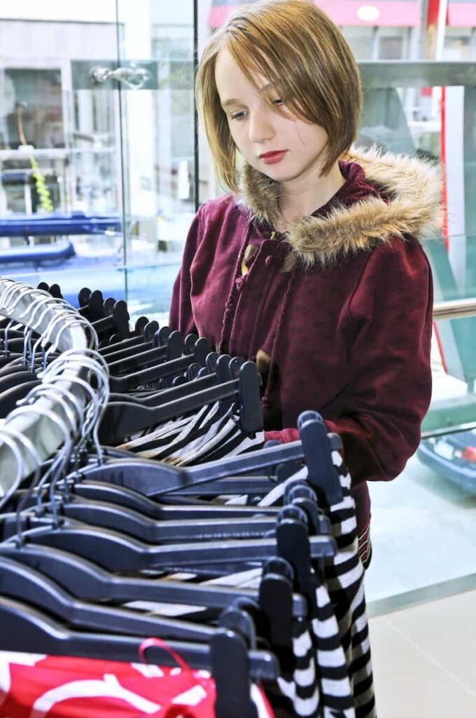 a woman doing her shopping at a Swedish clothing brand shop