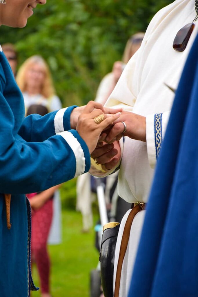 bride and groom holding hands for the Viking wedding ceremony